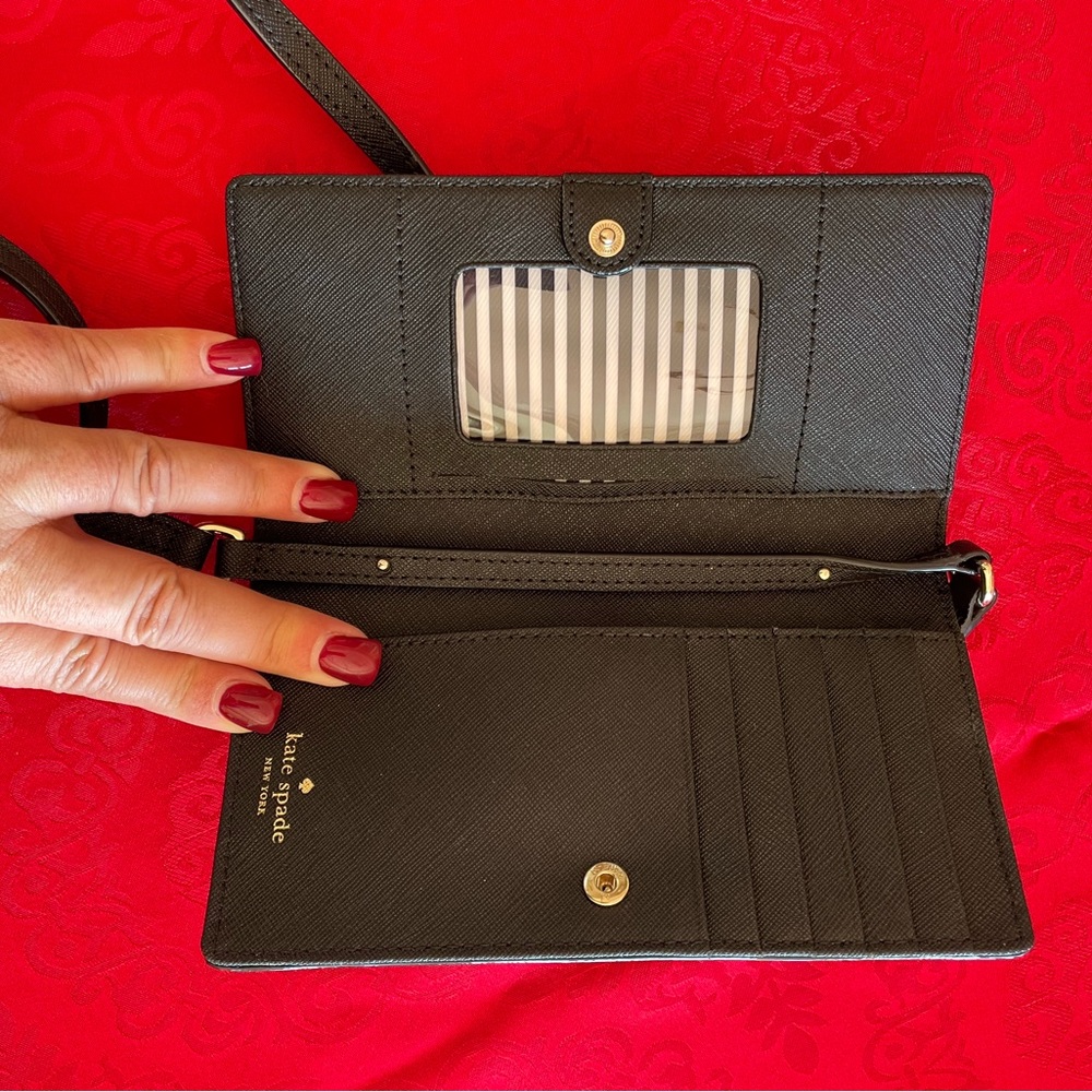 Kate Spade phone case/wallet. Never used. I think any size phone will fit.